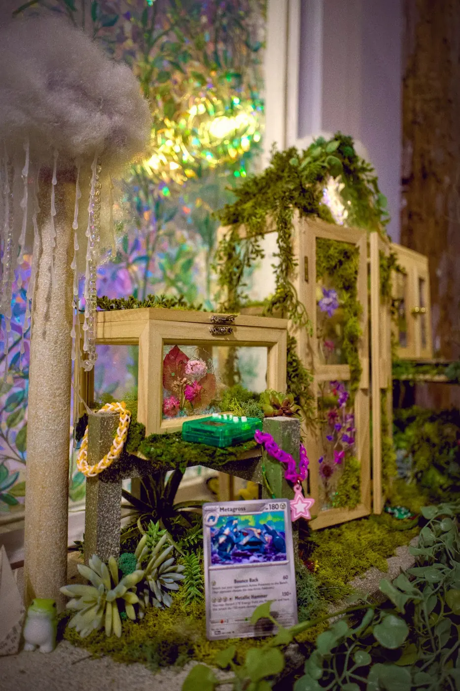 A tiny moss-covered greenhouse diorama under a cotton cloud, in front of a holographic window.